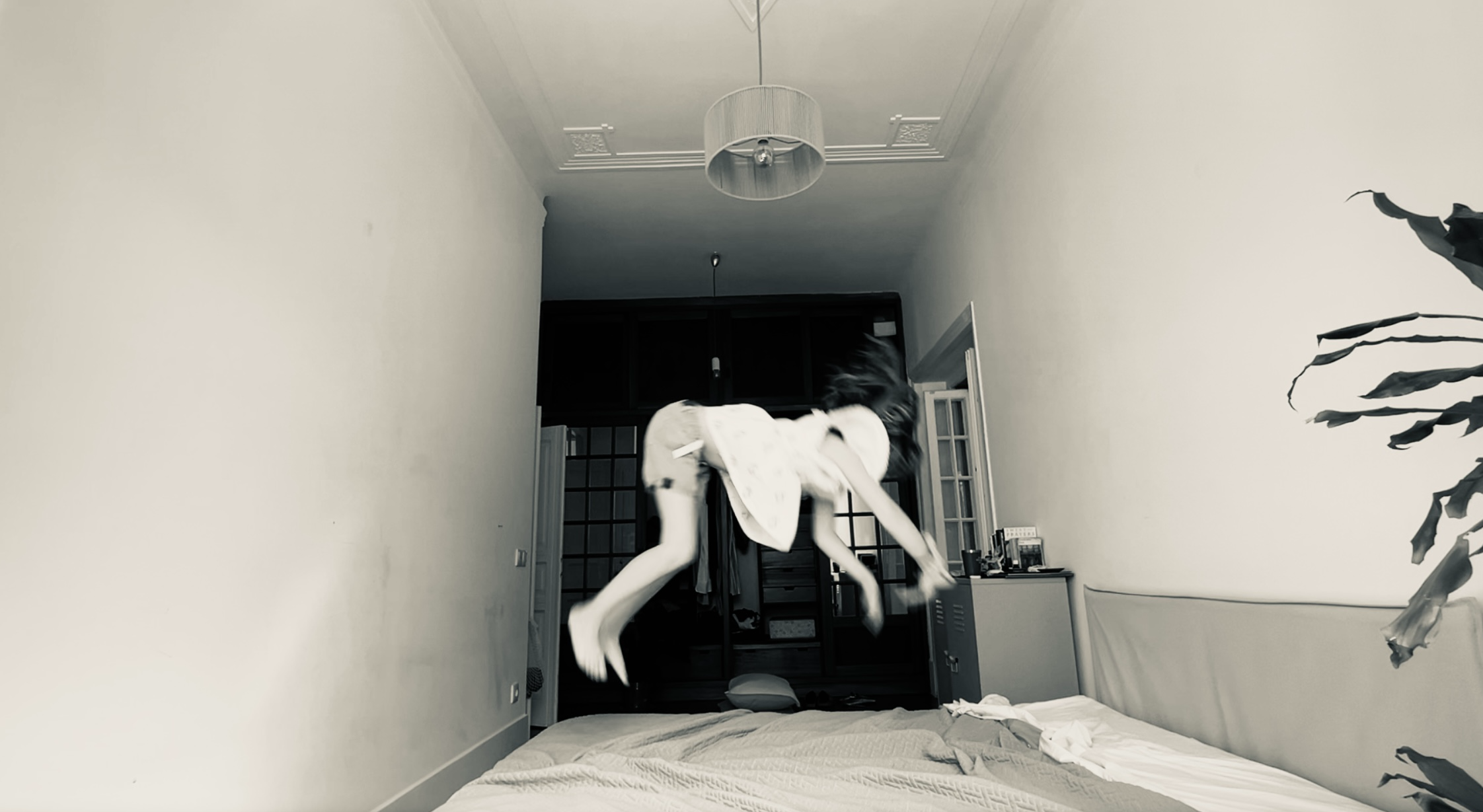 A child mid-leap, fully free